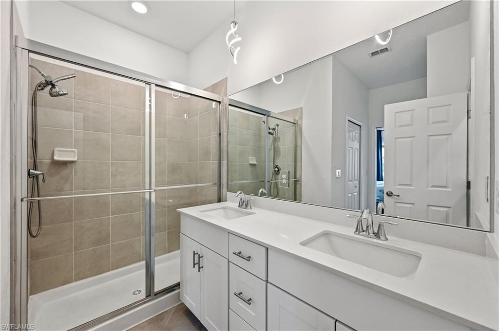 2828 Citrus Street Naples, FL 34120 - Photo 21 of 40 a bathroom with a shower sink and mirror