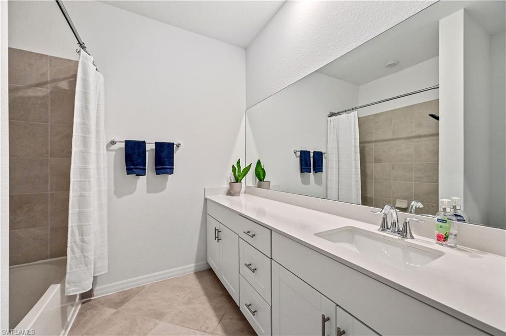 2828 Citrus Street Naples, FL 34120 - Photo 25 of 40 a spacious bathroom with a double vanity sink and mirror