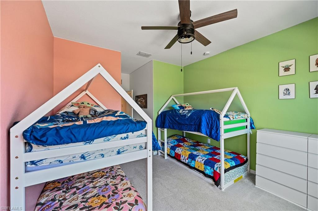 2828 Citrus Street Naples, FL 34120 - Photo 28 of 40 a bedroom with a bed and a baby crib