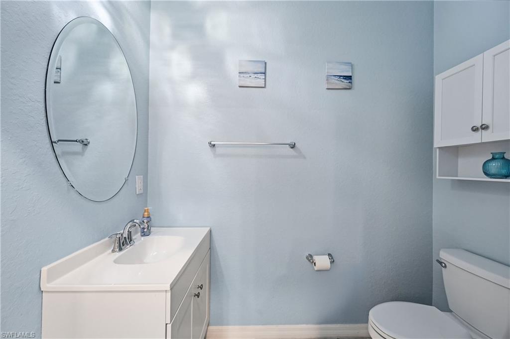2828 Citrus Street Naples, FL 34120 - Photo 29 of 40 a bathroom with a sink mirror and toilet