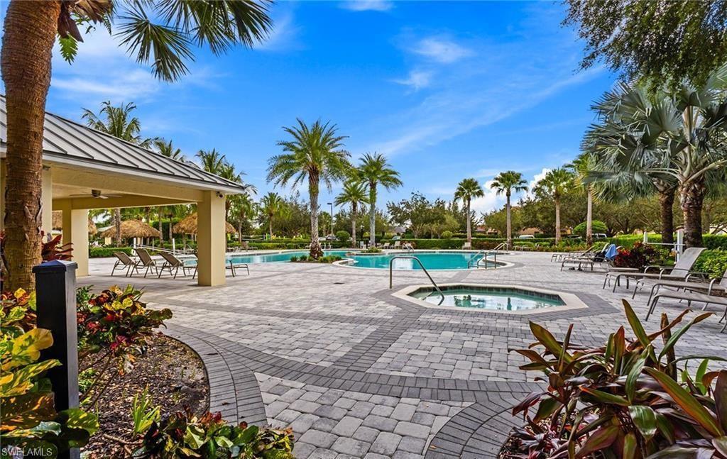 2828 Citrus Street Naples, FL 34120 - Photo 35 of 40 a view of a swimming pool with a table and chairs