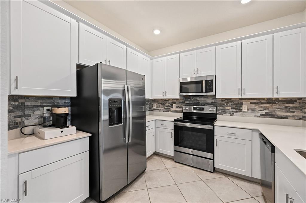 2828 Citrus Street Naples, FL 34120 - Photo 5 of 40 a kitchen with stainless steel appliances granite countertop a refrigerator stove and sink