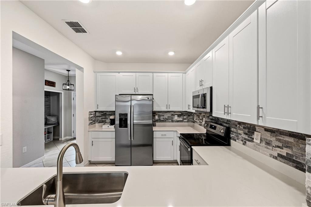 2828 Citrus Street Naples, FL 34120 - Photo 7 of 40 a kitchen with refrigerator and cabinets