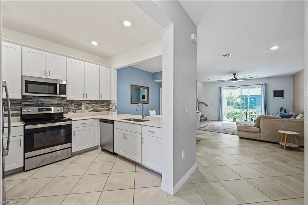 2828 Citrus Street Naples, FL 34120 - Photo 8 of 40 a kitchen with a stove a sink and a refrigerator