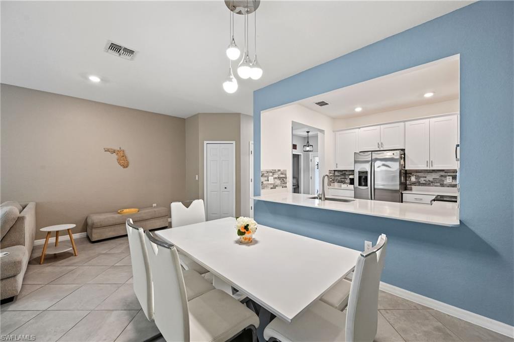 2828 Citrus Street Naples, FL 34120 - Photo 10 of 40 a large kitchen with a table and chairs