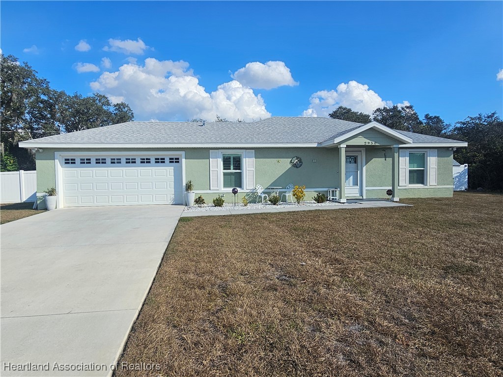 2950 North Sedgewick Road Avon Park, FL 33825 - Photo 16 of 16 a front view of house with yard and trees in the background
