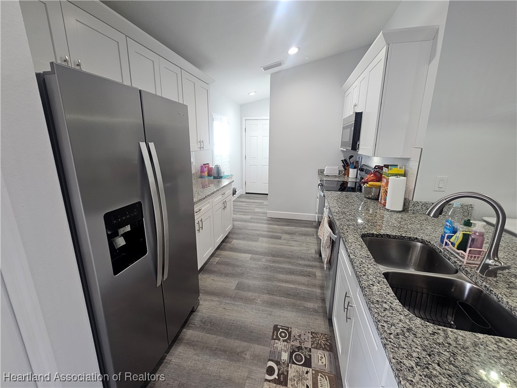 2950 North Sedgewick Road Avon Park, FL 33825 - Photo 2 of 16 a kitchen with stainless steel appliances a refrigerator and a sink