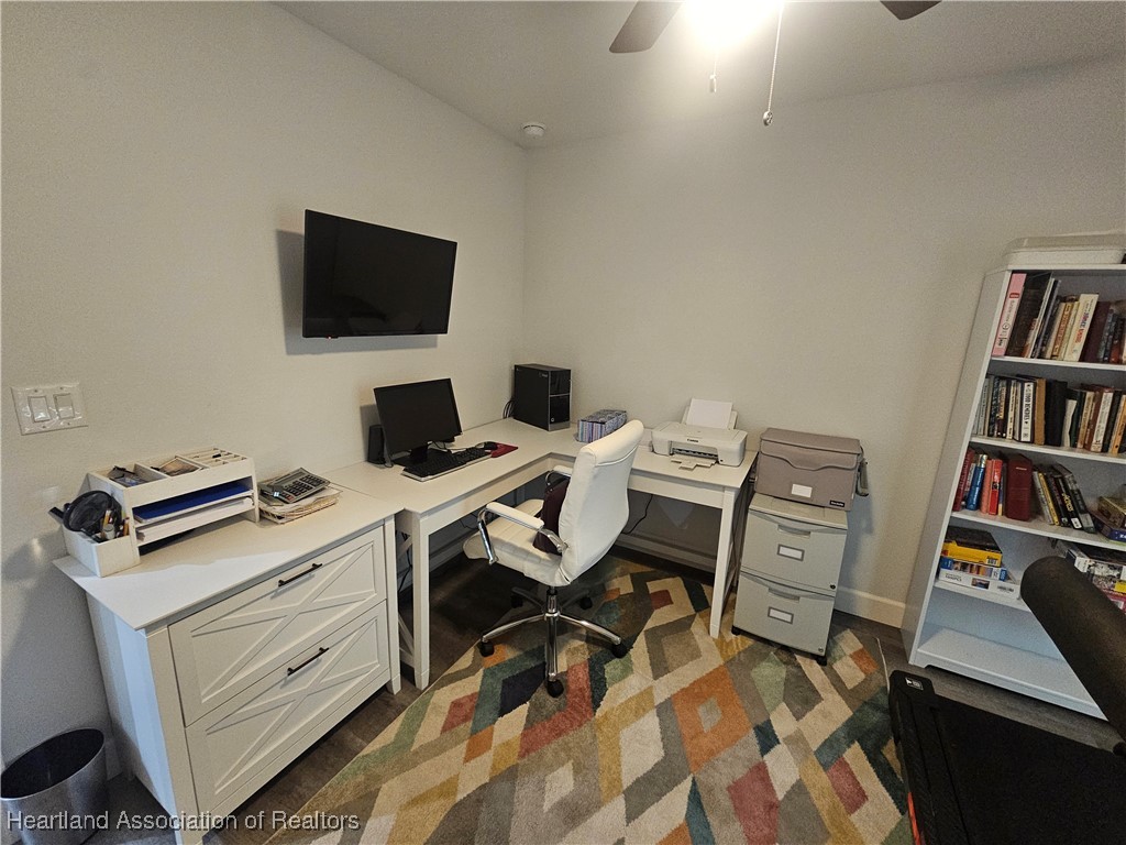 2950 North Sedgewick Road Avon Park, FL 33825 - Photo 7 of 16 a view of a workspace with furniture and a book shelf