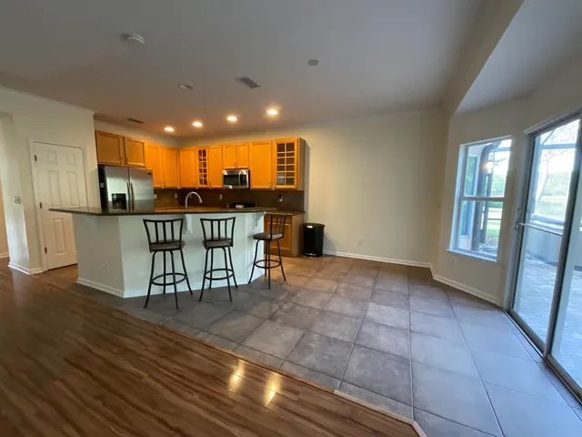 a view of a kitchen with dining room and wooden floor