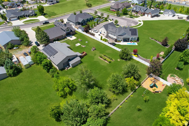 580 North 300 East Logan, UT 84321 - Photo 8 of 74 Aerial perspective showcasing a residential area with manicured lawns and mature trees