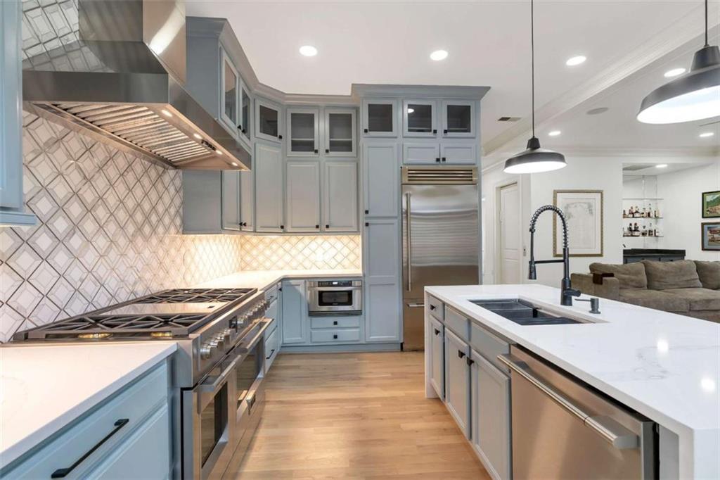 201 Riversgate Drive Atlanta, GA 30339 - Photo 26 of 69 a kitchen with stainless steel appliances granite countertop a sink and a stove top oven with wooden floor