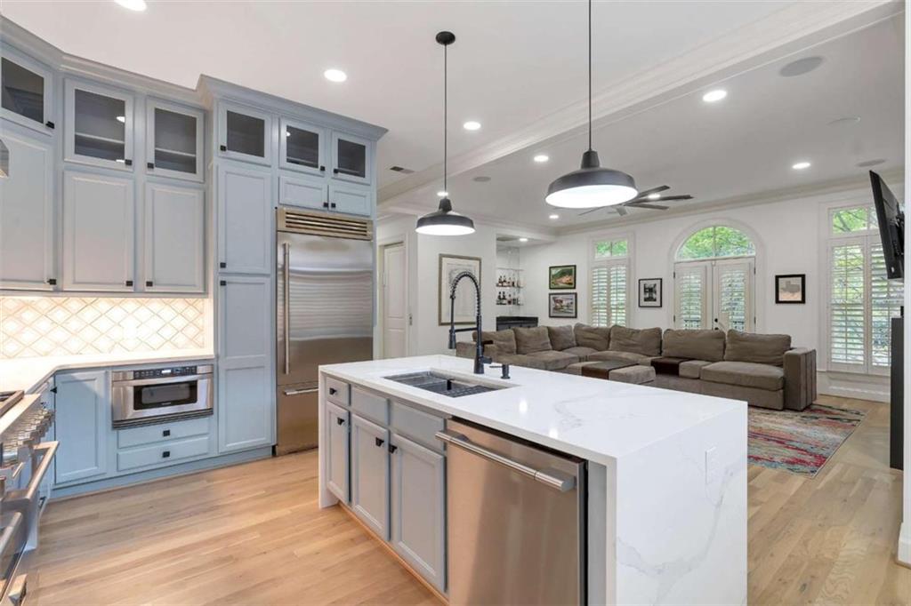 201 Riversgate Drive Atlanta, GA 30339 - Photo 27 of 69 a kitchen with kitchen island a sink stainless steel appliances and a center island