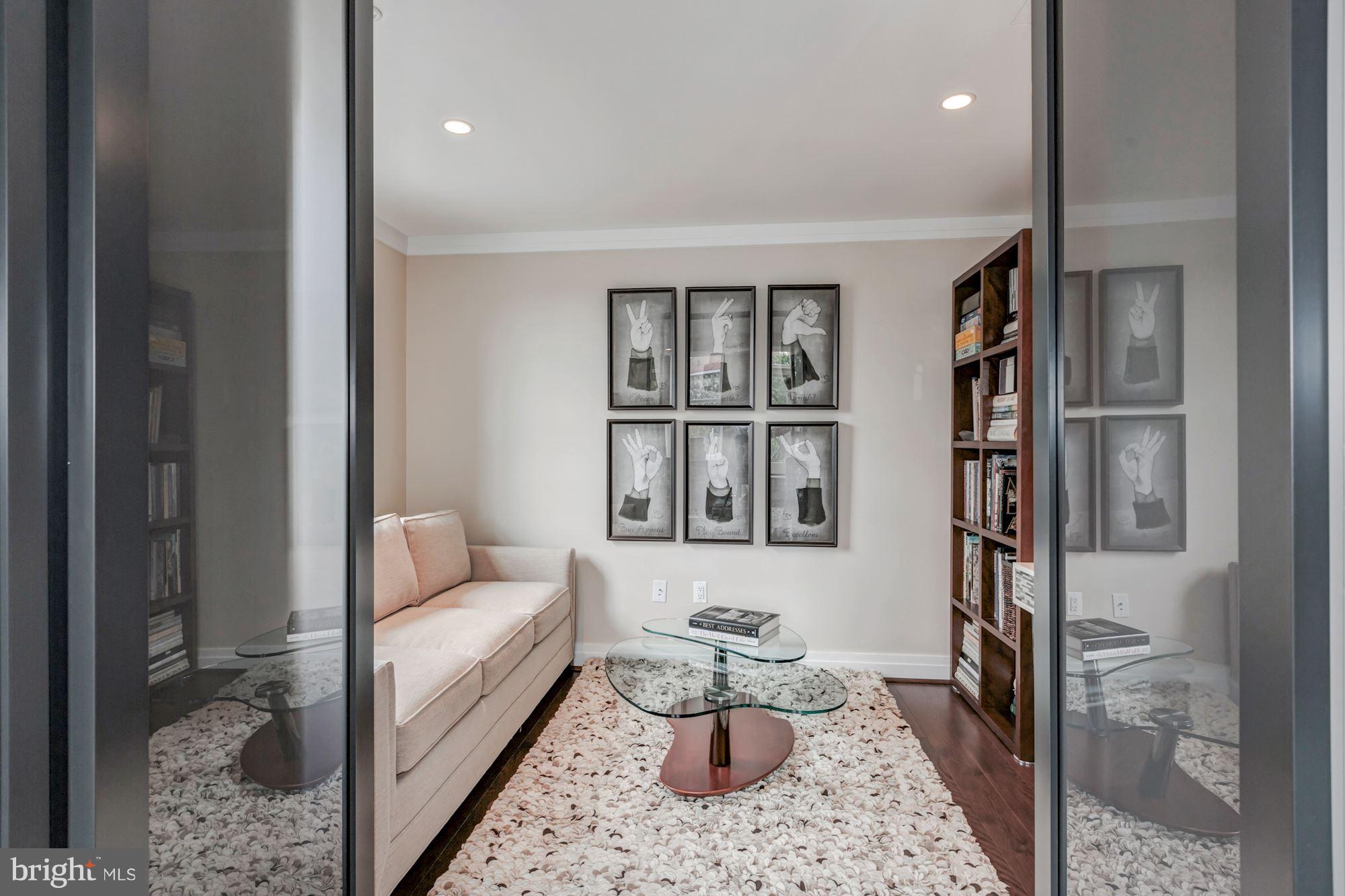 3052 R Street Northwest, Unit 301 Washington, DC 20007 - Photo 11 of 30 a living room with furniture and a book shelf