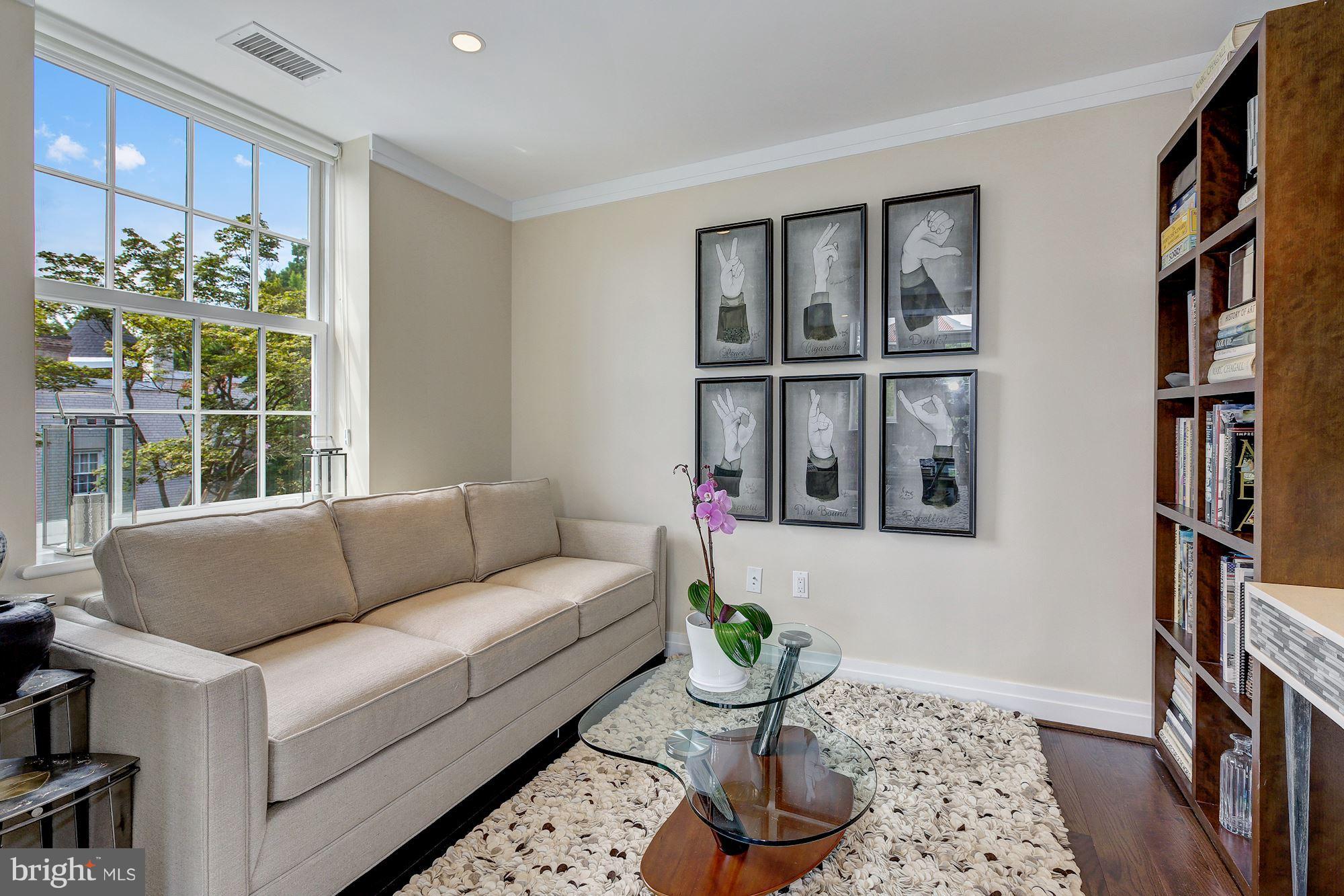 3052 R Street Northwest, Unit 301 Washington, DC 20007 - Photo 12 of 30 a living room with furniture and a window