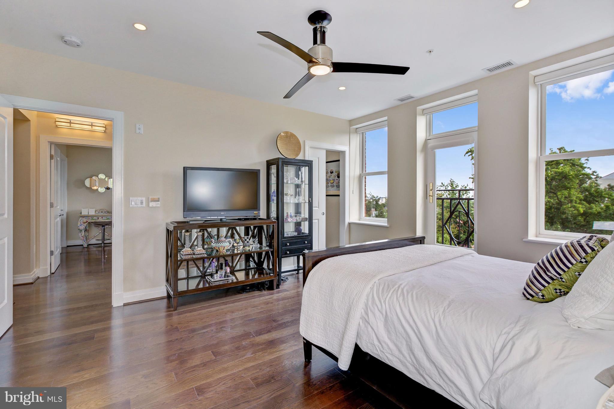 3052 R Street Northwest, Unit 301 Washington, DC 20007 - Photo 16 of 30 a bedroom with a bed and a flat screen tv
