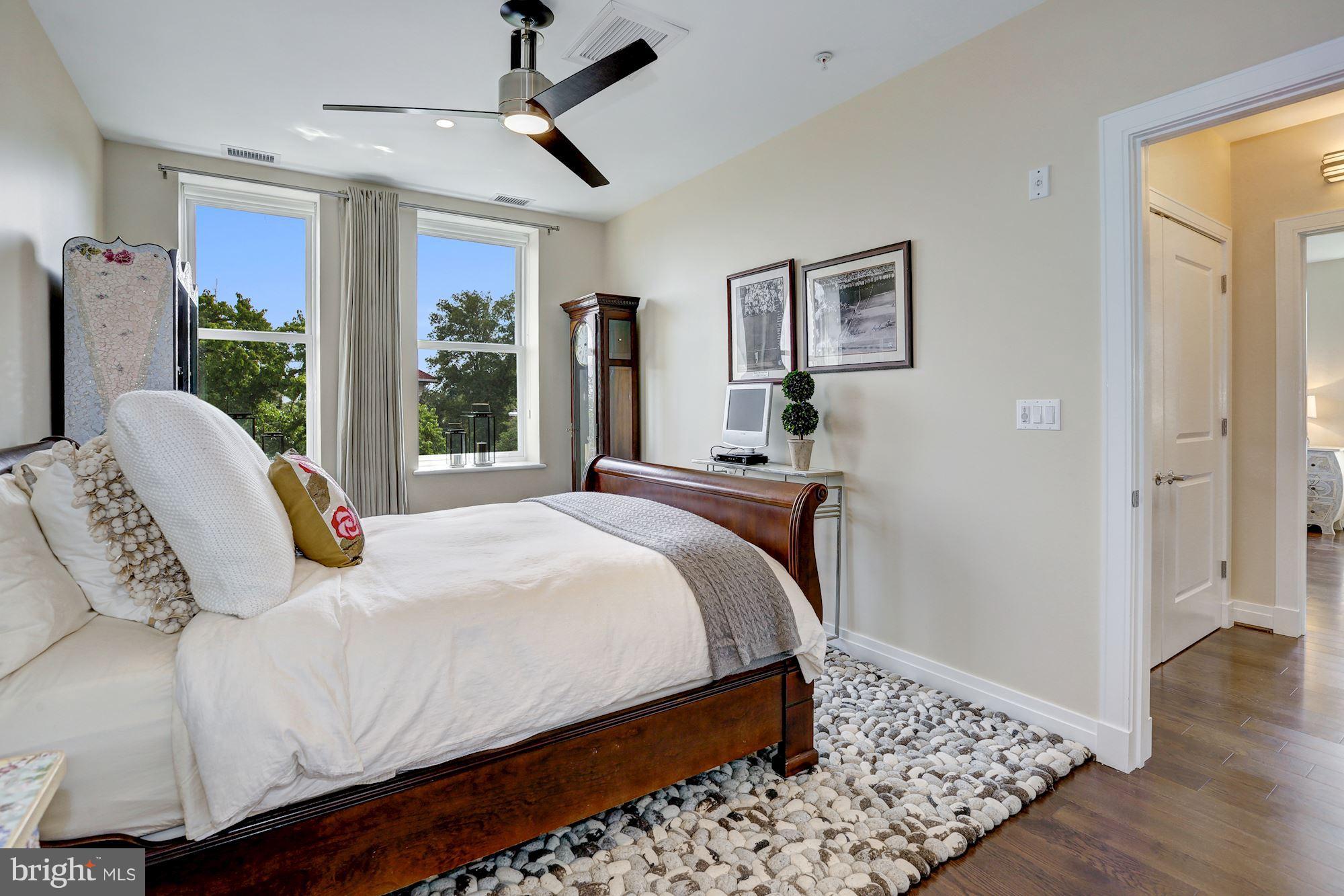 3052 R Street Northwest, Unit 301 Washington, DC 20007 - Photo 22 of 30 a bedroom with a bed painting on wall and a large window