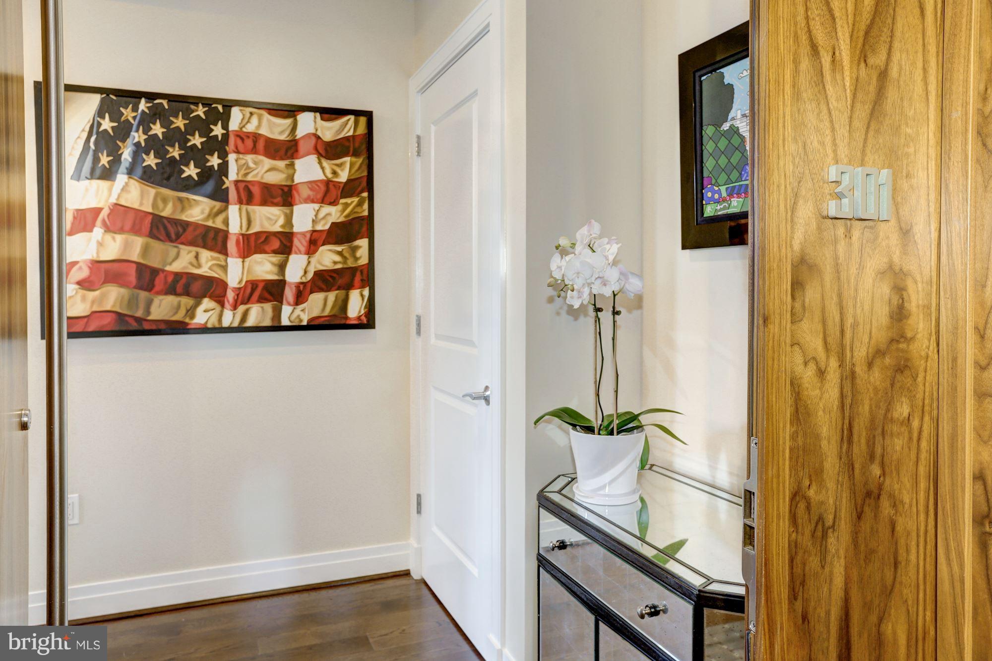 3052 R Street Northwest, Unit 301 Washington, DC 20007 - Photo 30 of 30 a view of a hallway with wooden floor and front door