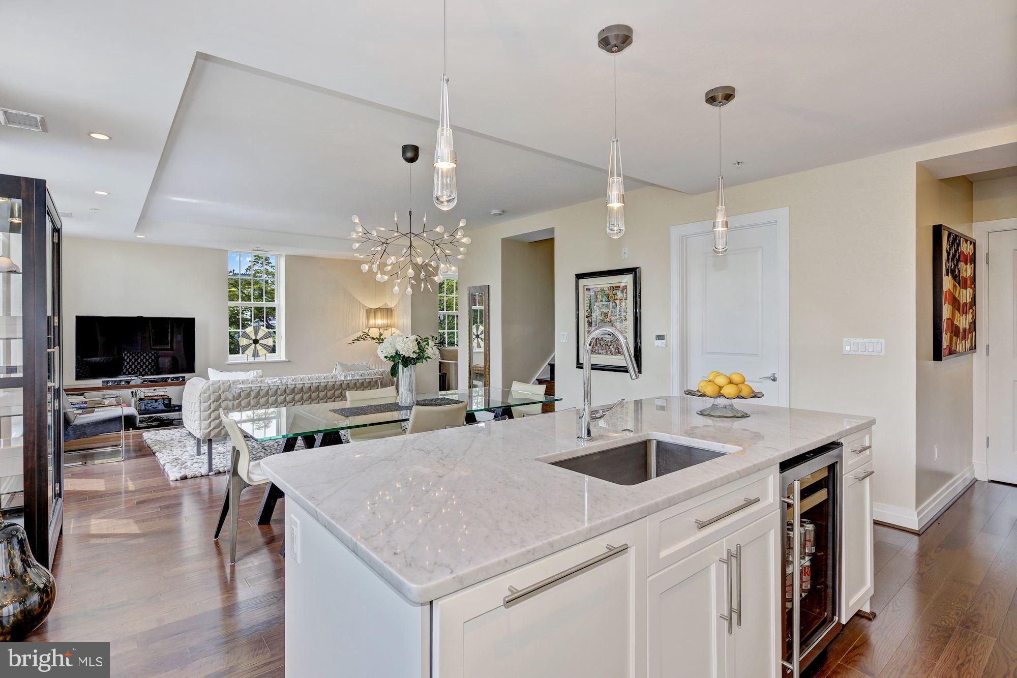 3052 R Street Northwest, Unit 301 Washington, DC 20007 - Photo 4 of 30 a view of kitchen island a sink table and chairs