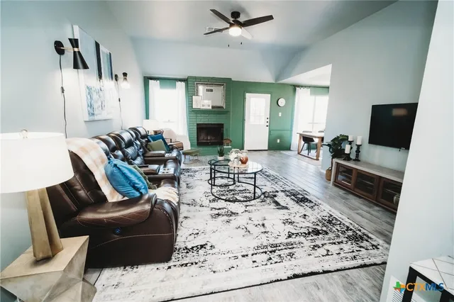 a living room with furniture and a flat screen tv
