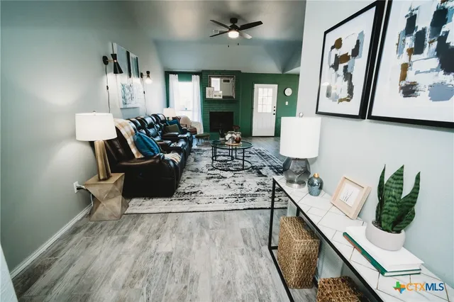 a living room with furniture and wooden floor