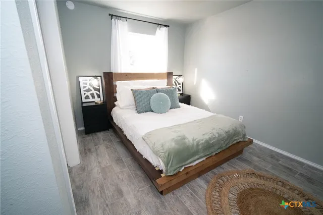 a bedroom with a bed and window