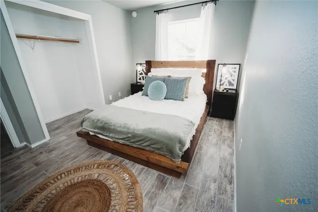 a bedroom with a bed and window