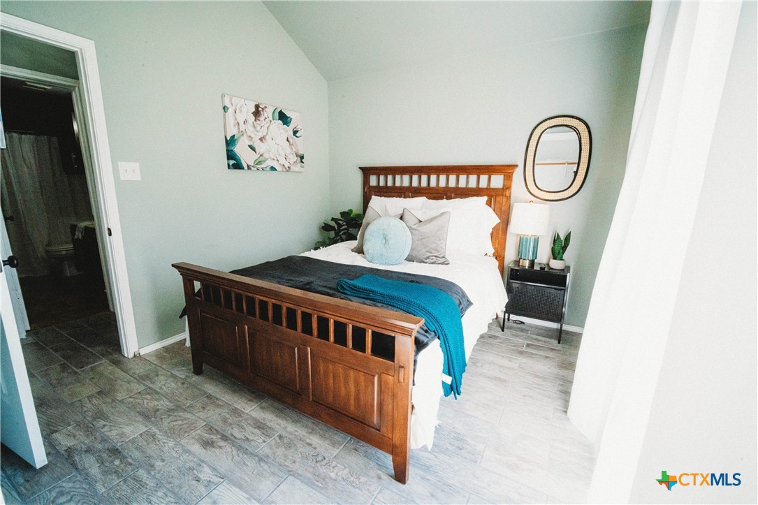 2607 Rampart Loop Killeen, TX 76542 - Photo 28 of 34 a bedroom with a bed and a mirror on dresser