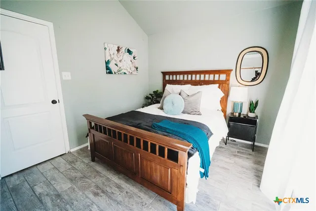 a large bed sitting in a bedroom next to a small yard