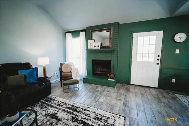 a living room with furniture and a fireplace
