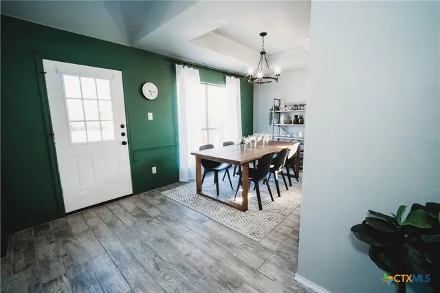 a dining room with furniture and window