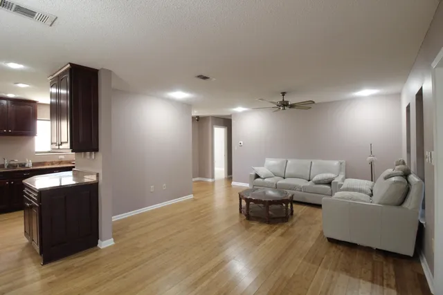 a view of a patio filled with furniture and garden