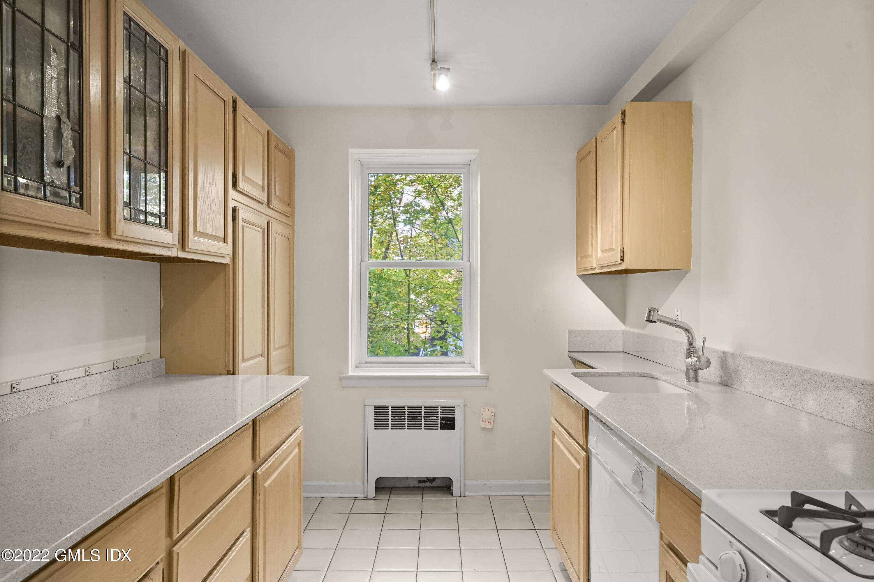 52 Lafayette Place, Unit 2H Greenwich, CT 06830 - Photo 5 of 11 a kitchen with a sink a stove and cabinets