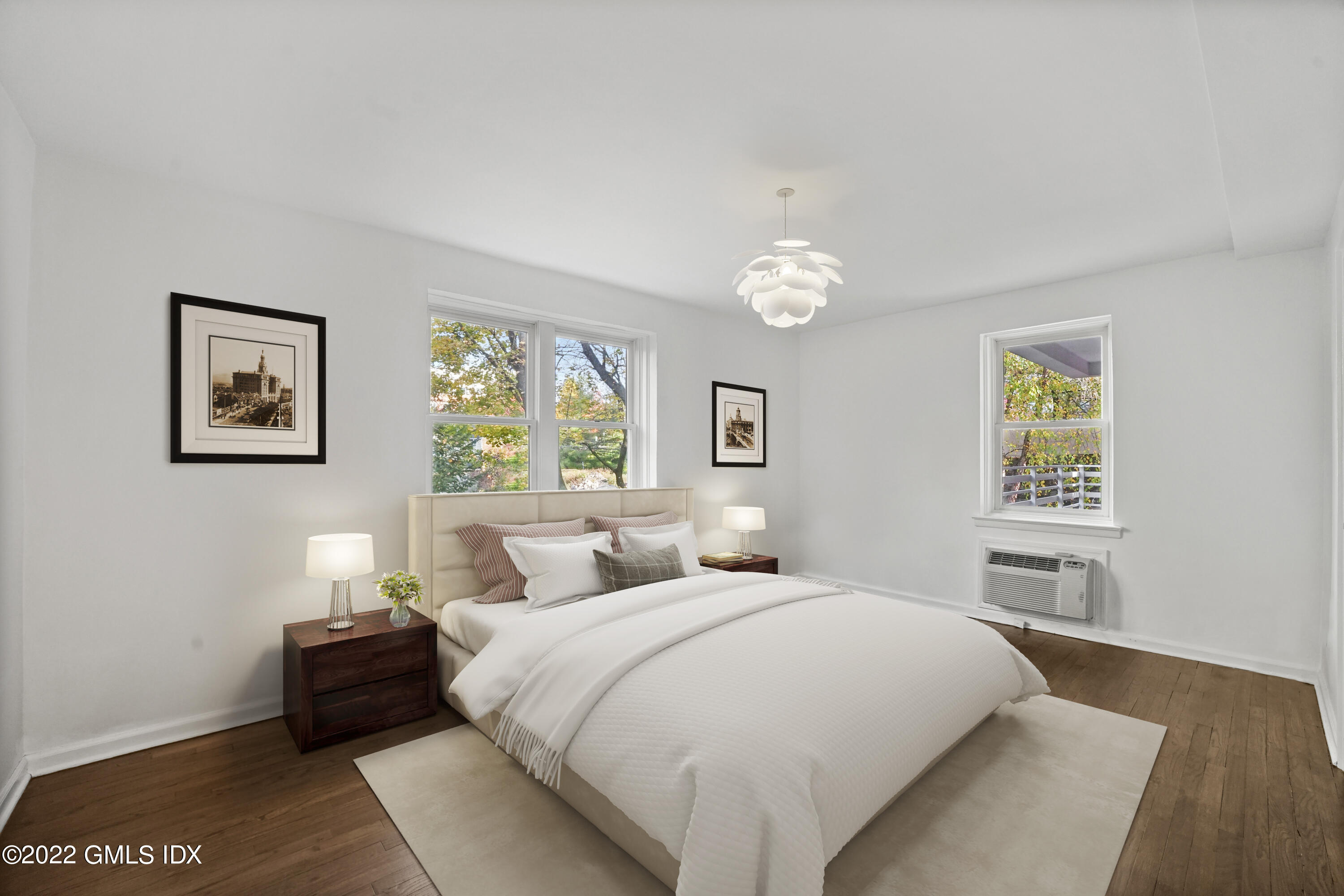 52 Lafayette Place, Unit 2H Greenwich, CT 06830 - Photo 6 of 11 a bedroom with a bed and a painting on the wall