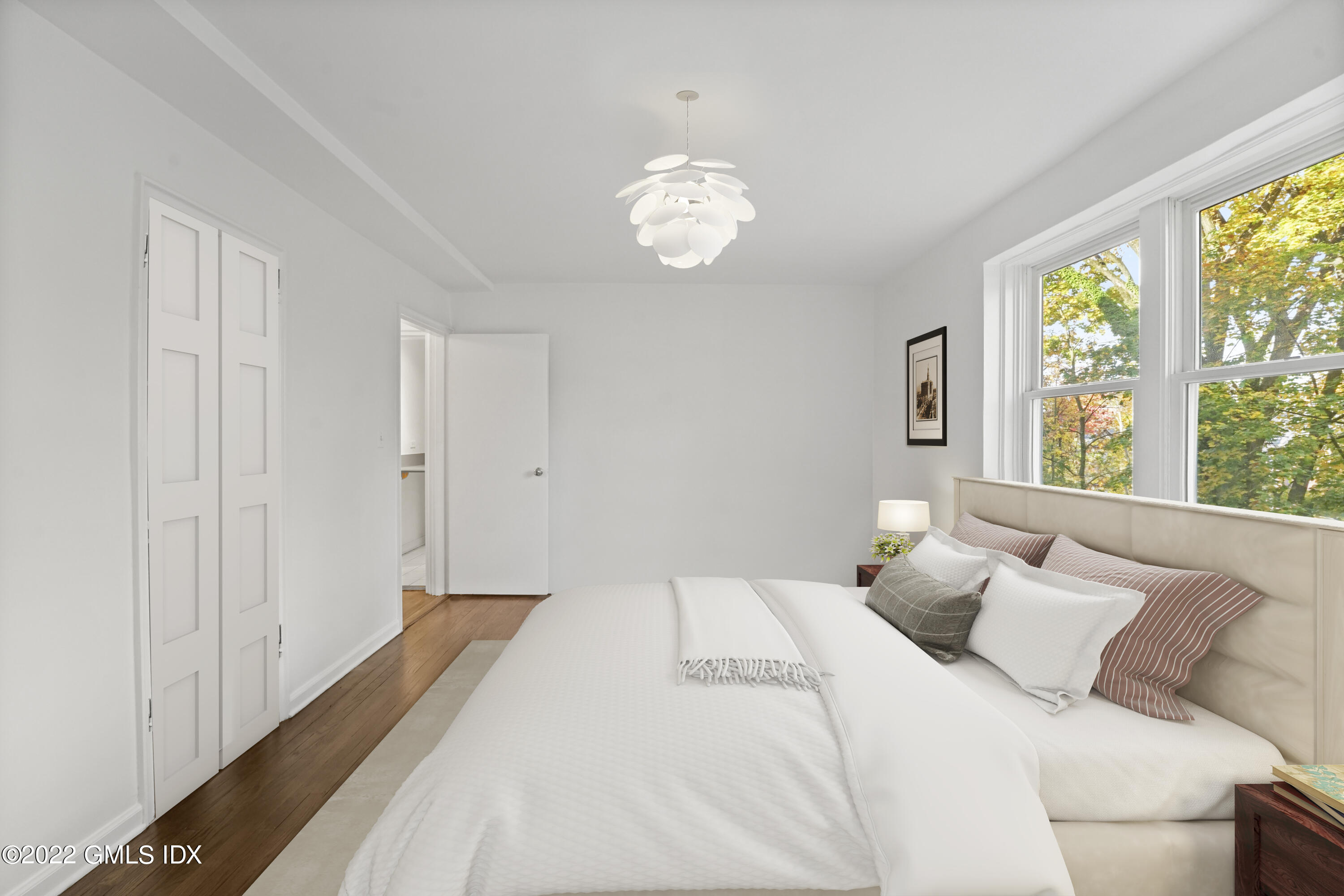 52 Lafayette Place, Unit 2H Greenwich, CT 06830 - Photo 7 of 11 a bedroom with a bed and a window