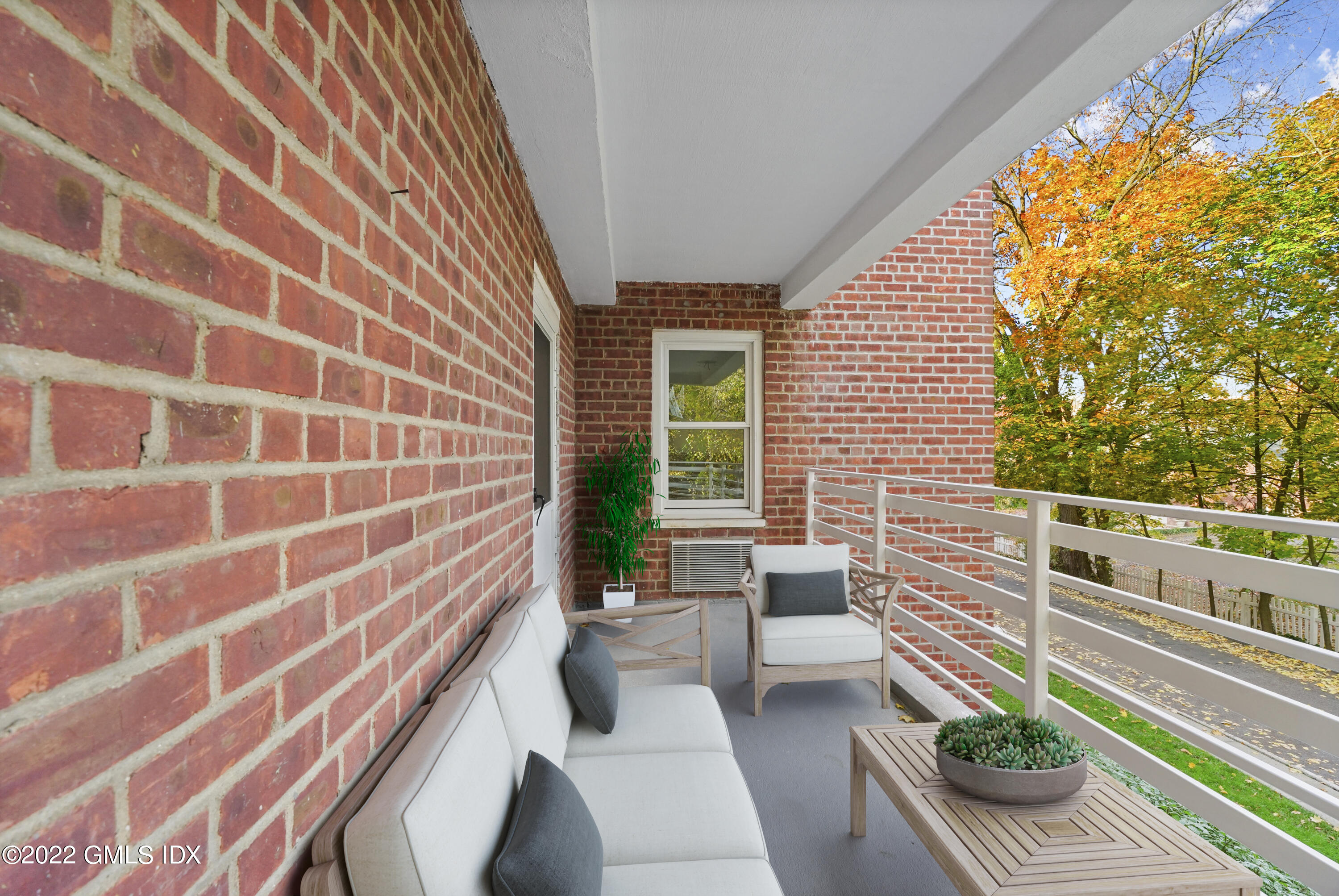 52 Lafayette Place, Unit 2H Greenwich, CT 06830 - Photo 8 of 11 a view of a patio with couches chairs and potted plants