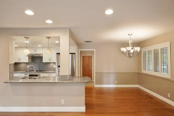 a view of kitchen with center island and wooden floor