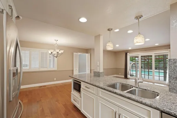 a kitchen with granite countertop a sink and window