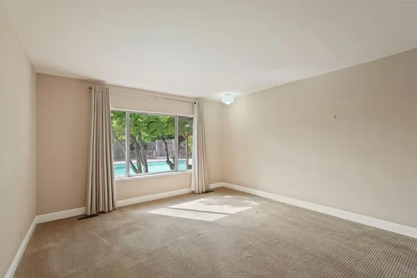 an empty room with an outdoor view and a window