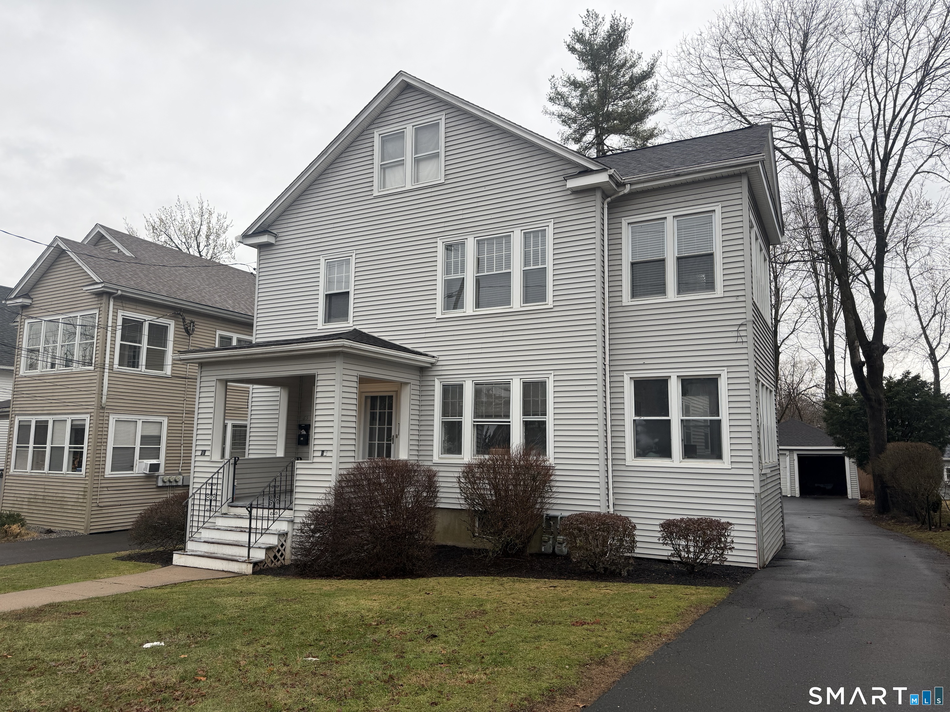 65 Burr Street West Hartford, CT 06107 - Photo 1 of 11 a front view of a house with a garden