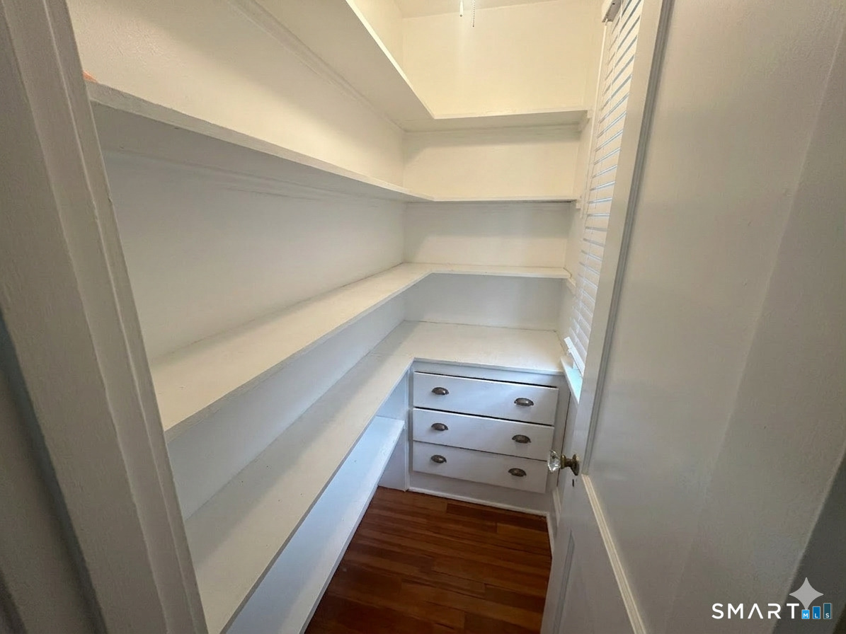 65 Burr Street West Hartford, CT 06107 - Photo 5 of 11 a view of walk in closet with empty racks