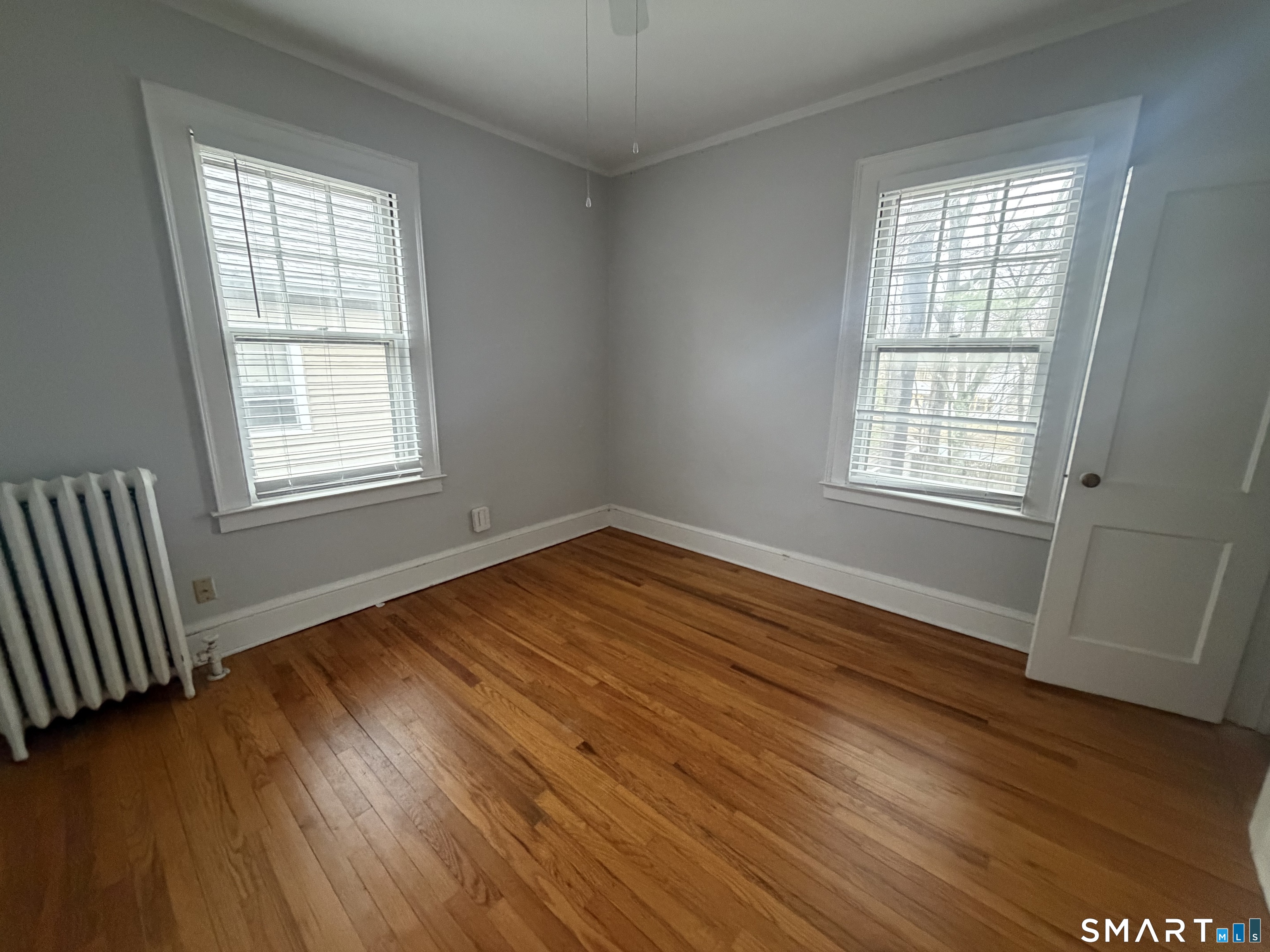 65 Burr Street West Hartford, CT 06107 - Photo 8 of 11 a view of an empty room with wooden floor and a window