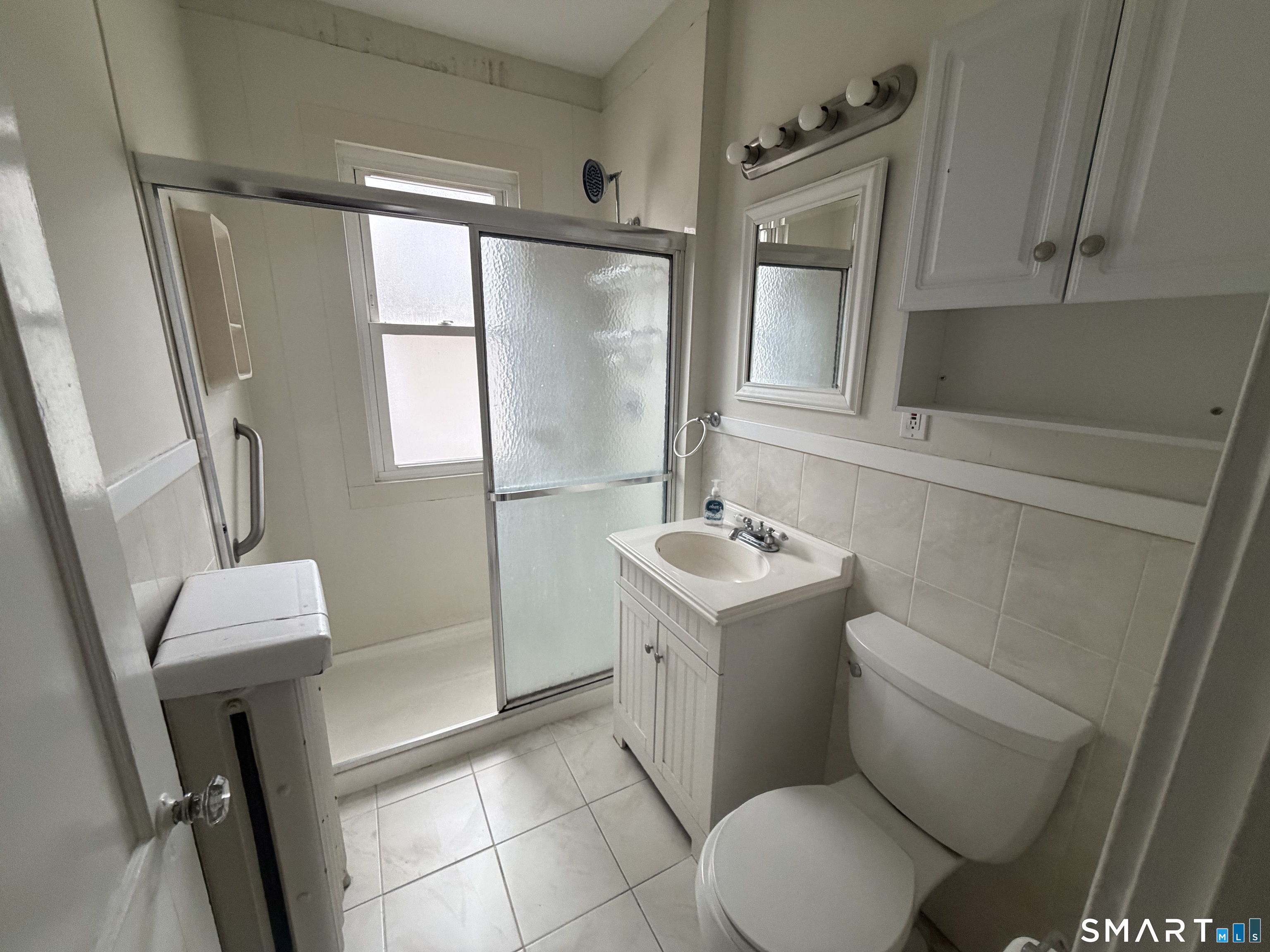 65 Burr Street West Hartford, CT 06107 - Photo 9 of 11 a bathroom with a sink toilet and shower