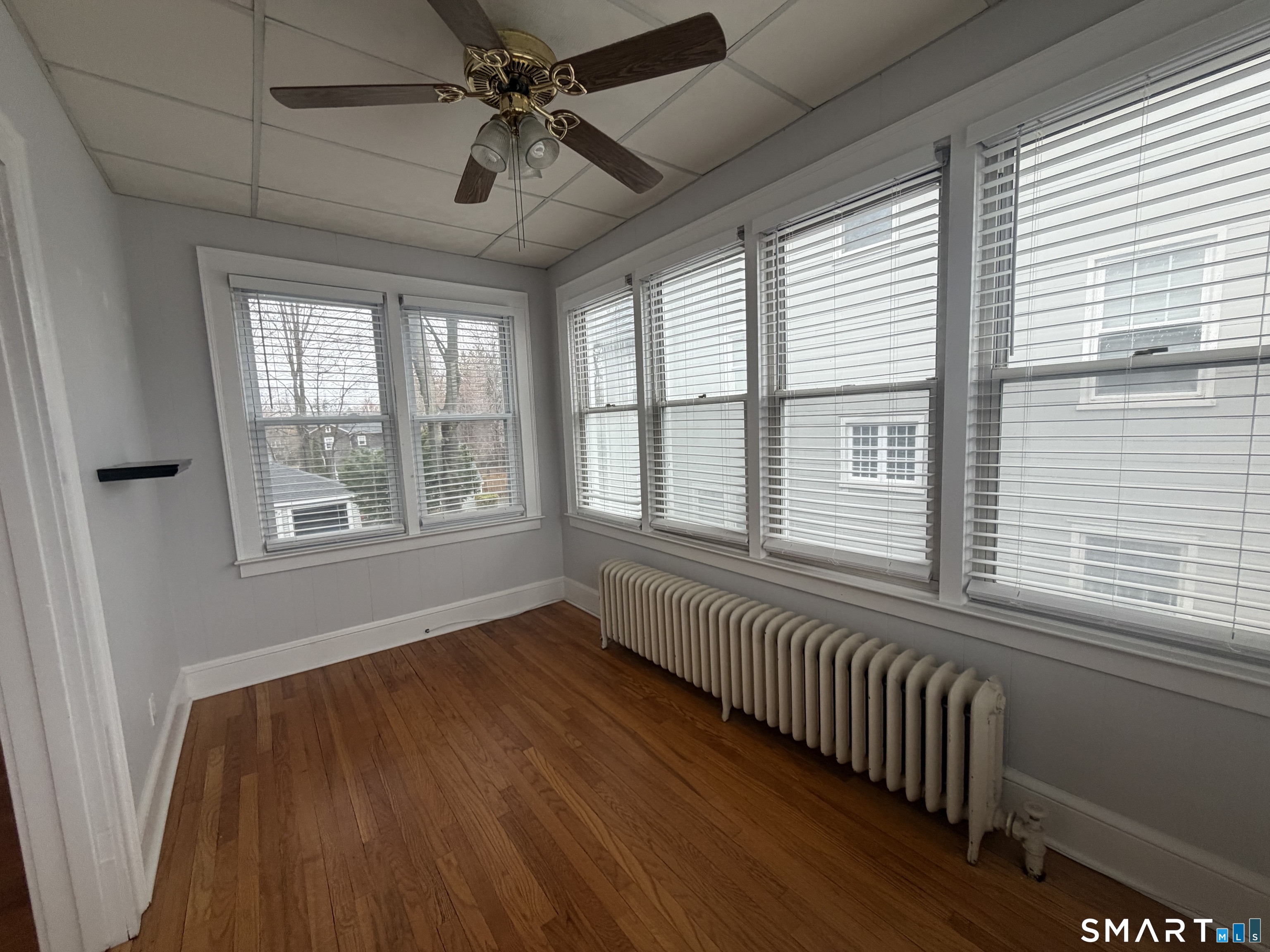 65 Burr Street West Hartford, CT 06107 - Photo 10 of 11 a view of an empty room with wooden floor and a window