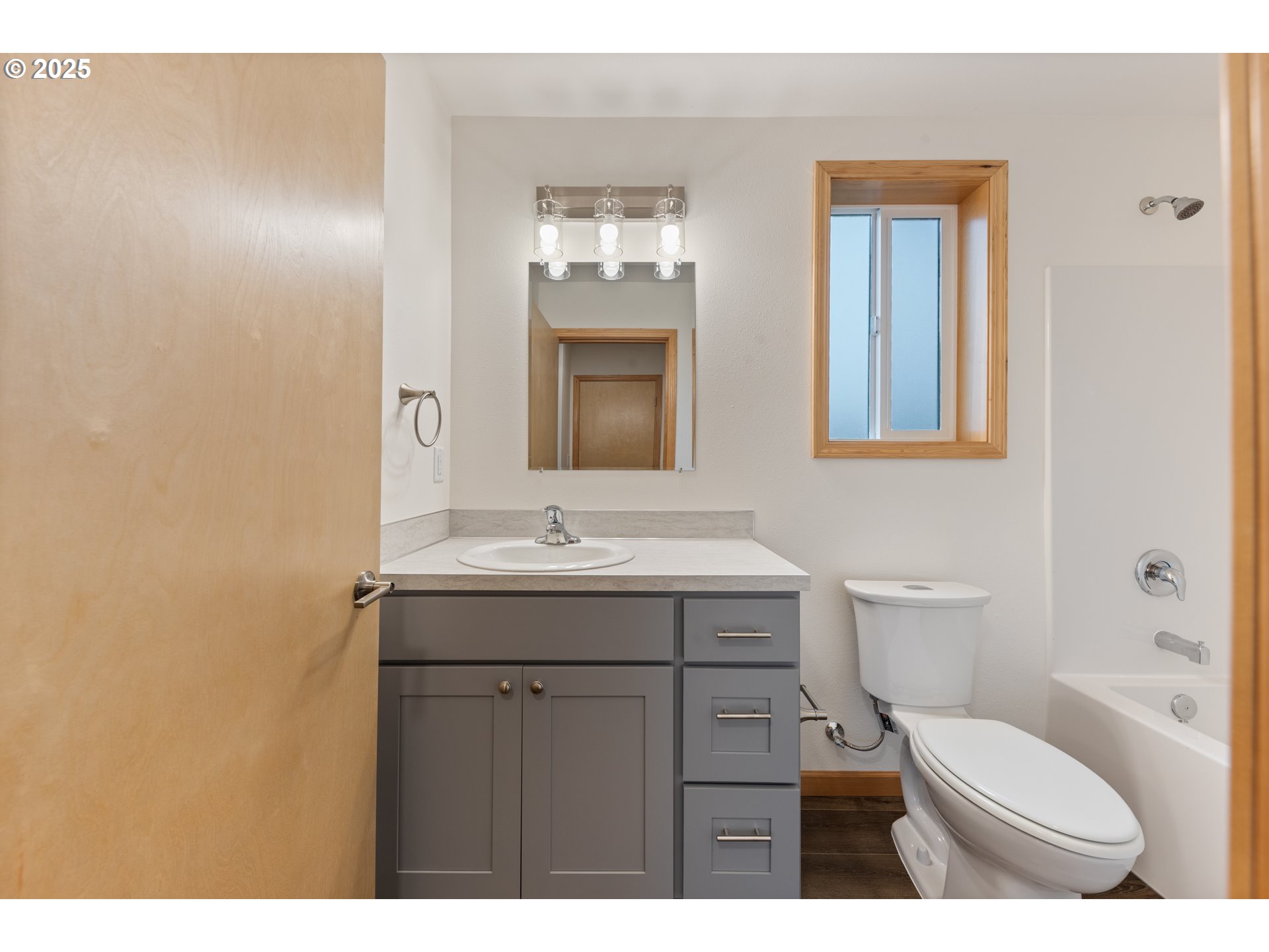 723 ST Charles Street Eugene, OR 97402 - Photo 19 of 30 a bathroom with a toilet a sink a mirror and vanity