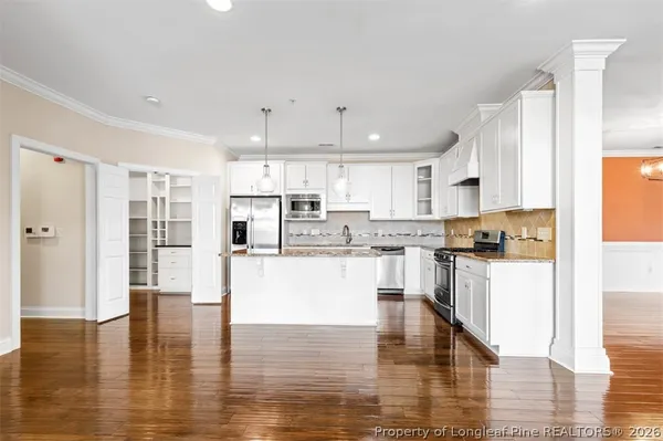 a large bathroom with a granite countertop sink a large mirror and a shower