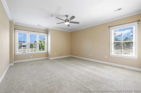 a kitchen with stainless steel appliances granite countertop a refrigerator a sink and white cabinets