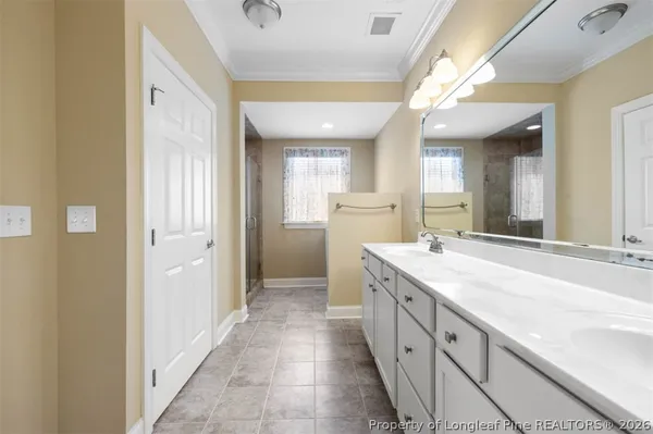 a living room with furniture floor to ceiling window and a flat screen tv