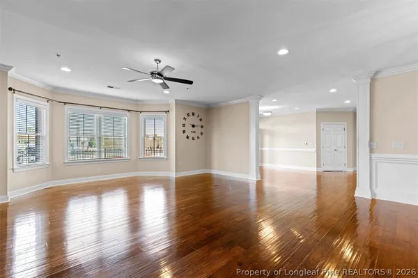 a kitchen with a refrigerator and a wooden floor