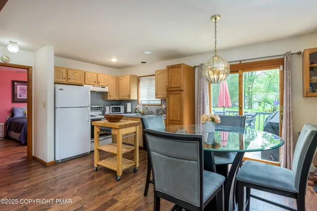 a kitchen with stainless steel appliances granite countertop a refrigerator a sink dishwasher a stove and a refrigerator