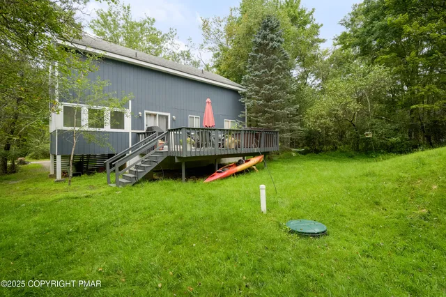a view of a house with a backyard